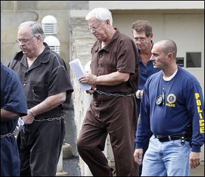 U.S. marshals escort, from left,  Bradford L. Huebner, of Ottawa Hills, Michael L. Teadt, of Maumee, and Charles N. Emmenecker, of Sylvania, from U.S. District Court in Toledo following their arraignment, Thursday.