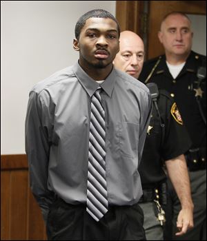 Charles Toyer is escorted into Lucas County Common Pleas Court in Toledo for the start of his trial, Monday, September 17, 2012. He is charged with the stabbing death of Tiffany Wilborn.