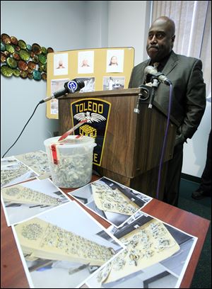 A bucket of mushrooms sits on a table as Toledo Police Chief Derrick Diggs speaks during a press conference Thursday.