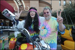 Sharon Hollins and Dan Frye stand with the two Honda motorcycles on display compliments of McElheney Locksmith at the Valentine Theatre's Summer's End benefit.