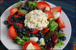 Delicious Southern Style Chicken Salad on a bed of greens, fruits and veggies.