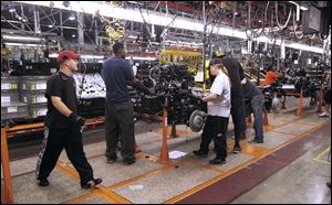 Cell leader Dale Frank, left, watches the Jeep Wrangler chassis line at the MOBIS plant in Toledo. MOBIS, which is one of the suppliers for the Jeep Wrangler at Chrysler's Toledo Assembly Plant, recently underwent a $10 million expansion project.