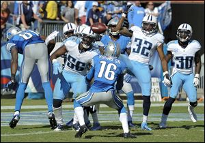 Detroit Lions wide receiver Titus Young (16) watches the ball before catching it after a pass was tipped by players in the end zone in the final moments of the fourth quarter at an NFL football game against the Tennessee Titans.