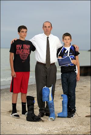 Erik Chappell of LaSalle Township, Mich., and and sons Grant, 14, left, and Cole, 12, gather with the casts Cole had to wear as a result of the car-bombing Sept. 20, 2011. All three were injured.