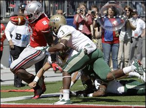 Ohio State's Rod Smith is knocked out of bounds just short of the goal line by Alabama-Birmingham's Lamarcus Farmer, front, Vashon Landers, right.