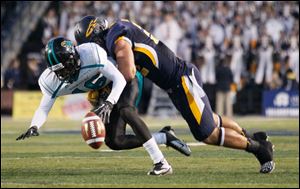 UT's Dan Molls hits Coastal Carolina's Tyrell Blanks causing an incomplete pass.