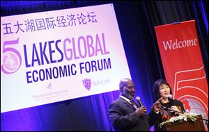 Toledo Mayor Mike Bell, will the help of Toledo Symphony Orchestra member Amy Chang interpreting, speaks at the 5 Lakes Global International Economic Forum at the Park Inn Hotel.