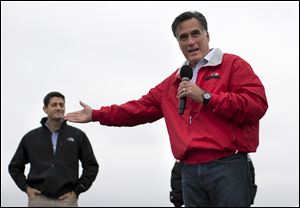 Republican presidential candidate, former Massachusetts Gov. Mitt Romney, right, speaks as vice presidential running mate Rep. Paul Ryan, R-Wis., looks on during a campaign rally on Tuesday in Vandalia, Ohio.