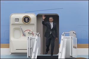 President Obama waves from Air Force One as he arrives at Toledo Express Airport.