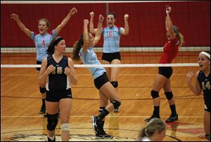 Eastwood High School volleyball players from left Mackenzie Albright, Allison Sutton, Elise Wolff and Aricka LaVoy, celebrate a point during a game against Tiffin Columbian in Pemberville.