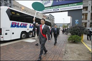 Local and Chinese business leaders follow an interpreter to a waiting bus for a tour of the region Wednesday as part of the 5 Lakes Global Economic Summit.