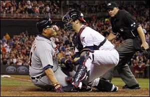 Tigers' Miguel Cabrera is tagged out at home plate by Minnesota Twins catcher Joe Mauer on Friday night in Minneapolis.