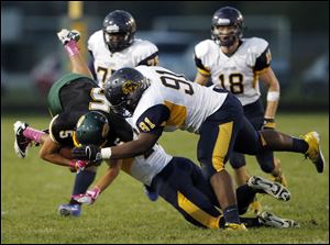 Clay's Anthony Ramirez (5) collides with  Whitmer's Marquise Moore (91).