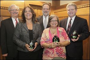 From left, rear: Joe Tafelski, executive director of Advocates for Basic Legal Equality, Inc.; Kevin Mulder, executive director of Legal Aid of Western Ohio, Inc, and David Coyle, president of the Board of Trustees of the two non-profit law firms. ABLE/LAWO received the Large Agency Excellence award. From left, front: Tammy Holder, executive director of Beach House Family Shelter, and Vicki Obee-Hilty, executive director of Bittersweet Farms. Beach House received the Small Agency excellence award, and Bittersweet Farms received the Innovation award.  The second Northwest Ohio Nonprofit Innovation & Excellence Awards