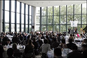 Simon Guo, president of 5 Lakes Global, gives the keynote speech for the 5 Lakes Global International Economic Forum held at Fifth Third Center. The event attracted 160 businessmen, educators, government officials, and educators from China to commingle with an equal number of businessmen and leaders from northwest Ohio and southeast Michigan.