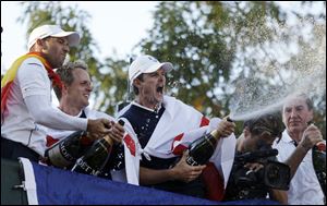 Europe's Sergio Garcia, left to right, Luke Donald and  Justin Rose celebrate after winning the Ryder Cup PGA golf tournament Sunday, at the Medinah Country Club in Medinah, Ill.