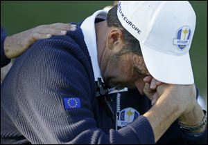 European team captain Jose Maria Olazabal holds his head down on the 17th hole during a singles match at the Ryder Cup PGA golf tournament Sunday.
