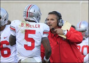 Ohio State coach Urban Meyer speaks with Braxton Miller. Meyer said he didn't know if his offense could respond the way it did.