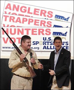 David Dlubak, owner of the Ithaca Gun Company, presents Republican vice presidential candidate, Rep. Paul Ryan, R-Wis., with a special edition Romney/Ryan Ithaca shotgun before Ryan speaks to the U.S. Sportsmen's Alliance annual banquet Saturday in Columbus. A Romney/Ryan logo was engraved on the stock of the gun.