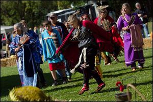 Jozie Waters, 13, of Camen, center, participated in a women's dance inside the sacred circle during this year's 