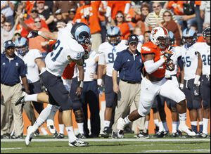 Bowling Green's BooBoo Gates gets a block from a teammate on Rhode Island punter Tim Wienclaw on an 80-yard punt return for a touchdown in the first quarter.