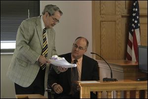 John Weglian, assistant county prosecutor, left, and, on the witness stand, Christopher F. Parker, Esq., attorney for The Skutch Company, Ltd., reviewing documents. The Skutch Company was the court-appointed receiver for the Tony Packo's, Inc.