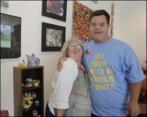 Linda Richards and Tyler Wiley show off some of their artwork at Shared Lives Studio, which will have a table selling  art at the upcoming Buddy Walk to benefit the Down Syndrome Association of Greater Toledo.