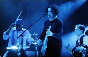 Jack White, center, performs at Lollapalooza in Chicago's Grant Park on Sunday, Aug. 5.