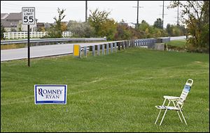  An empty chair sits next to a Romney/Ryan sign Tuesday at Roachton Road and Hull Prairie Road in Perrysburg. About a month remains until Election Day. 