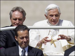Pope Benedict XVI, flanked by his private secretary Georg Gaenswein, top left, and his butler Paolo Gabiele at St.Peter's square at the Vatican.