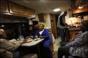 The Cumberland Family eat dinner in their RV which is parked in the YMCA parking lot as part of the local Sleep Out the Vote campaign in Toledo.