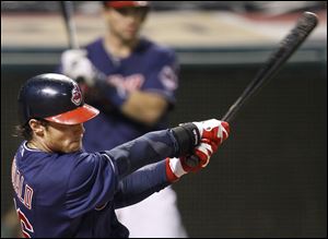 Cleveland Indians' Jason Donald hits an RBI single off Chicago White Sox's Nate Jones in the 12th inning.