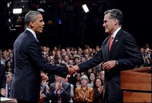 President Barack Obama shakes hands with Republican presidential nominee Mitt Romney after their first presidential debate tonight at the University of Denver.