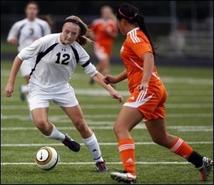 Perrysburg's Maddy Williams moves the ball against Sylvania Southview's Morgan Ersig on Wednesday in Perrysburg.
