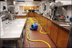 Cleaning equipment does its work in the kitchen area of the Islamic Center of Greater Toledo, which sustained damage in every room, said center President Mahjabeen Islam.