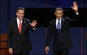 Republican presidential nominee Mitt Romney and President Barack Obama  wave to the audience during the first presidential debate at the University of Denver on Wednesday.