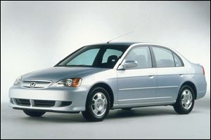 This 2003 Honda Civic Hybrid looks just like its gasoline-powered siblings, but its key attribute is a hybrid engine that runs on both gasoline and electricity. 