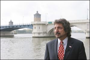 Lucas County commissioner candidate Kevin Haddad speaks at a press conference Wednesday along the banks of the Maumee river outside One Maritime Plaza.