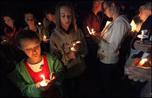 Family members of Border Patrol Agent Nicholas Ivie participate on Thursday in a candlelight ceremony in Naco, Ariz. 