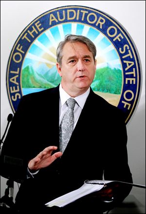 State auditor of Ohio Dave Yost goes over the School Attendance Data Interim Report during a press conference Thursday in Columbus.