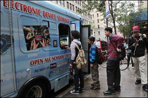 Cellphones are banned in all New York City public schools, but the rule is widely ignored except in schools with metal detectors. Outside those schools, entrepreneurs park trucks where students drop off devices before class and get them back at the end of the day.