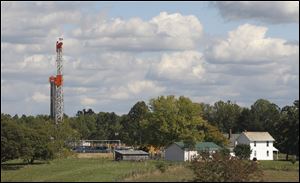 A drill rig across the street from a farmhouse in Carrollton, Ohio.