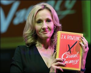 British writer J.K. Rowling poses for the photographers with her new book, entitled: 'The Casual Vacancy', at the Southbank Centre in London. 