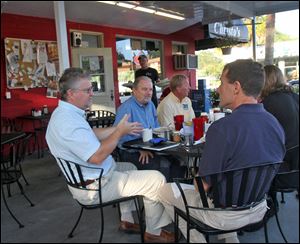 Gary Rackliff, left, V.P. Build the U.S., gestures to  Dudley Powell, right, as building professionals meet for breakfast in Orlando, Florida, to plan US-made houses and a related web site.