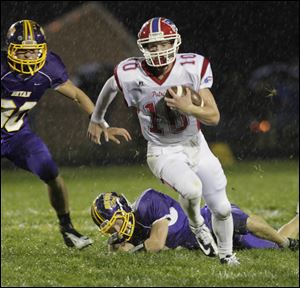 Bryan defenders put pressure on Patrick Henry quarterback Gabe Jones during their Northwest Ohio Athletic League matchup on Friday night.