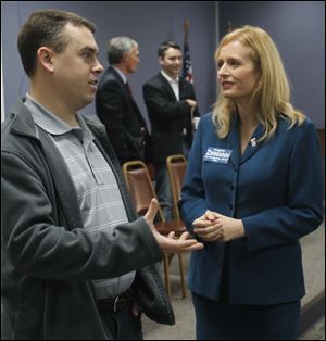 Libertarian state House of Representatives candidate Nathan Eberly converses with Democratic U.S. Congressional District 5 candidate Angela Zimmann.