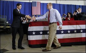 Republican vice-presidential candidate Paul Ryan shakes hands with retired U.S. Army Sgt. Ryan Mack of Defiance after Mack introduced Mr. Ryan.  Mack was injured while serving in Afghanistan.