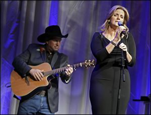 Trisha Yearwood is accompanied by her husband, Garth Brooks, as she sings 