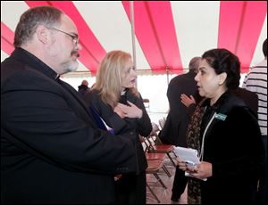 The Rev. Martin Otto Zimmann, left, his wife, Rev. Angela Zimmann, Ph.D., and Dr. Mahjabeen Islam, president of the Islamic Center of Greater Toledo, talking after the event. Over 600 people come together in a 
