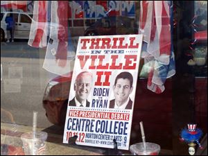 A sign in a business window touts the vice presidential debate at Centre College in downtown Danville, Ky.
